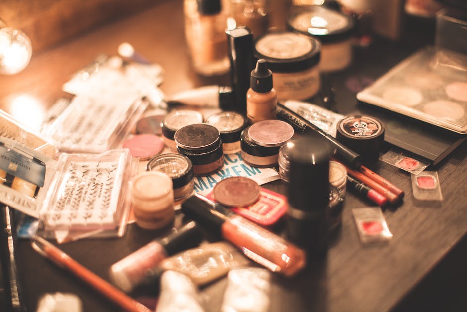 Various cosmetics and makeup products displayed on a vanity table. Ideal for beauty and fashion themes