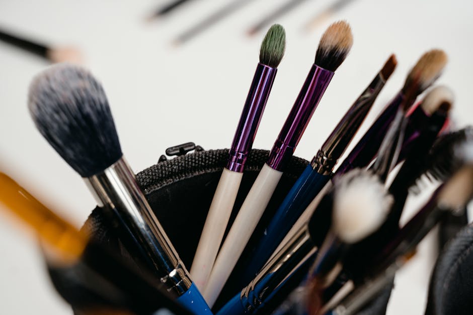 A close-up view of various makeup brushes arranged in a holder, ideal for beauty products and cosmetics themes